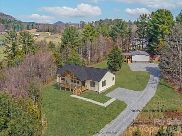 an aerial view of a house with yard and green space