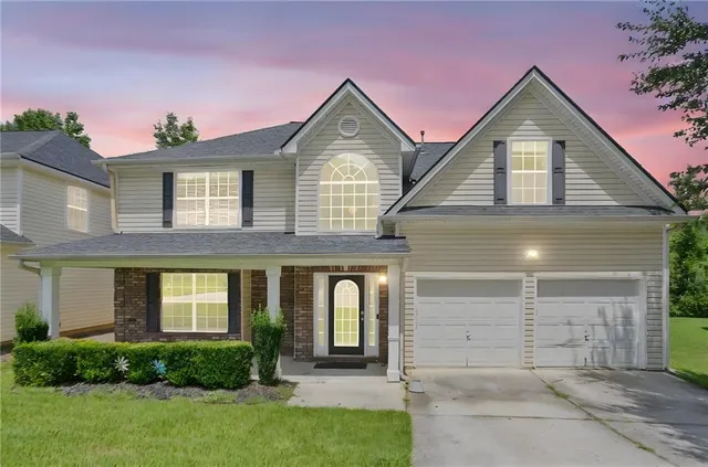a front view of a house with garden
