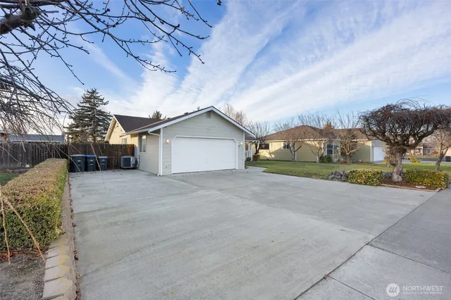 a view of a house with a yard and garage