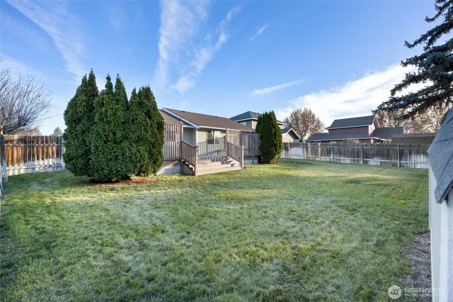 a view of a house with a backyard