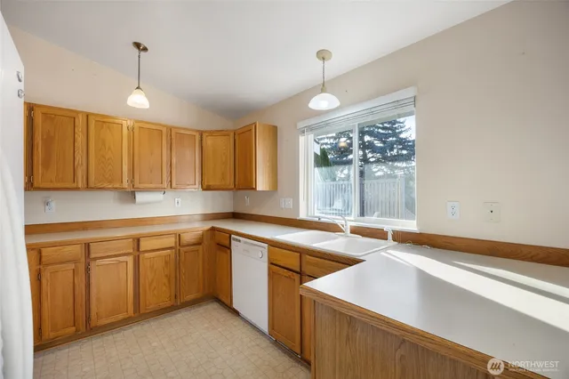 a kitchen that has a sink stove and cabinets