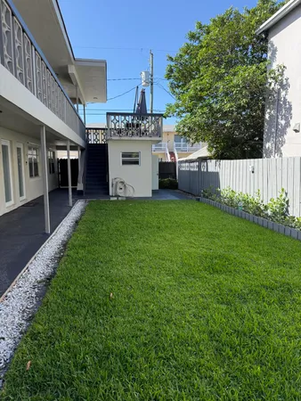 a view of a house with a yard and deck