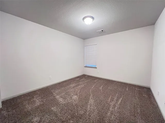 an empty room with a empty space and windows