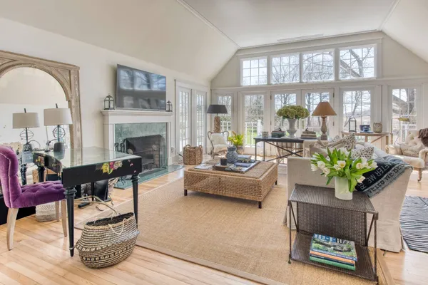 a living room with furniture a chandelier and a fireplace