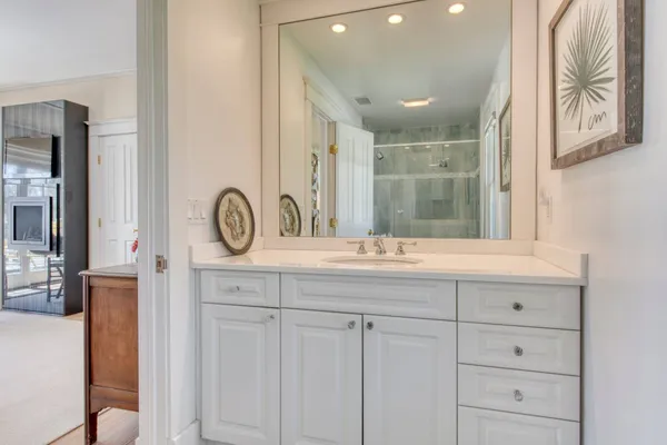 a bathroom with a sink a mirror and a vanity
