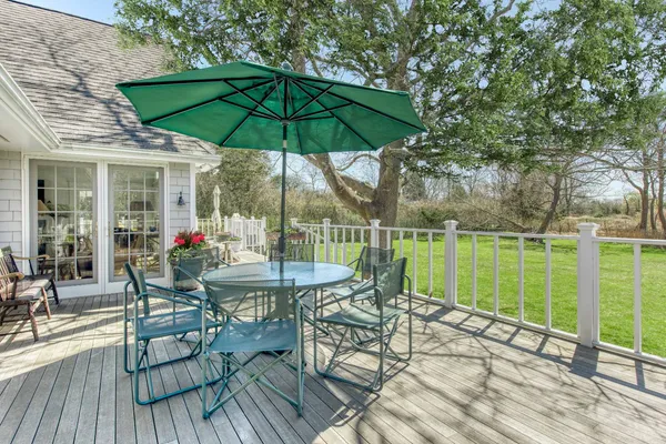 a outdoor view with a sitting space and large trees