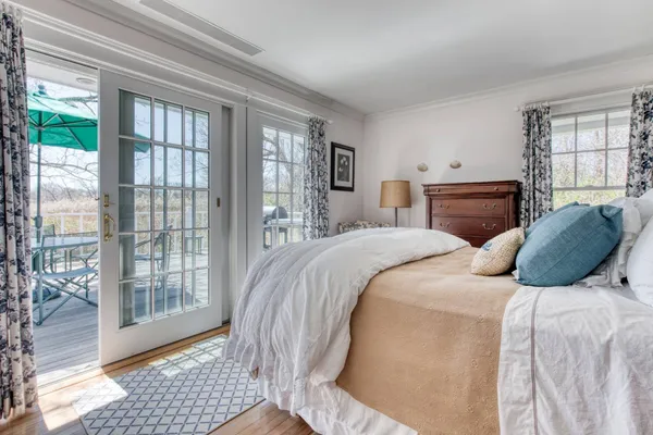 a bedroom with a large bed and a window