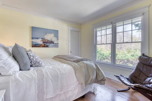 a bedroom with a bed and a large window