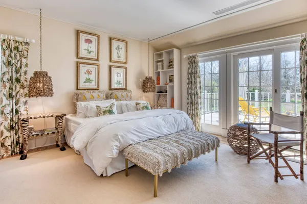 a spacious bedroom with a bed and a couch