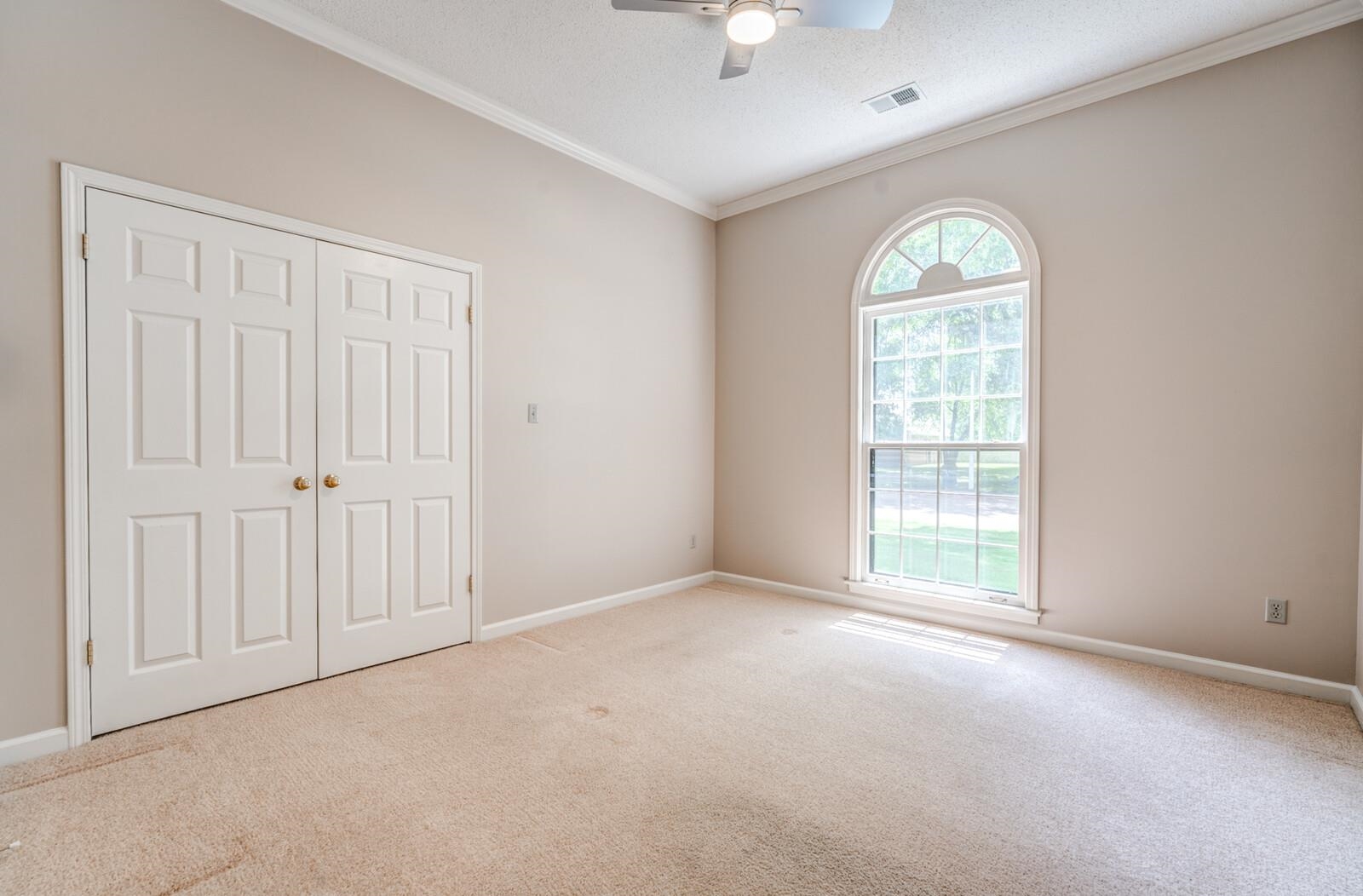 8198 Walnut Creek Road Memphis, TN 38018 - Photo 22 of 32 10' ceiling with crown molding, double door closet and NEW ceiling fan/light.