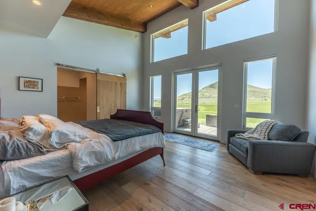 a bedroom with bed couch and window