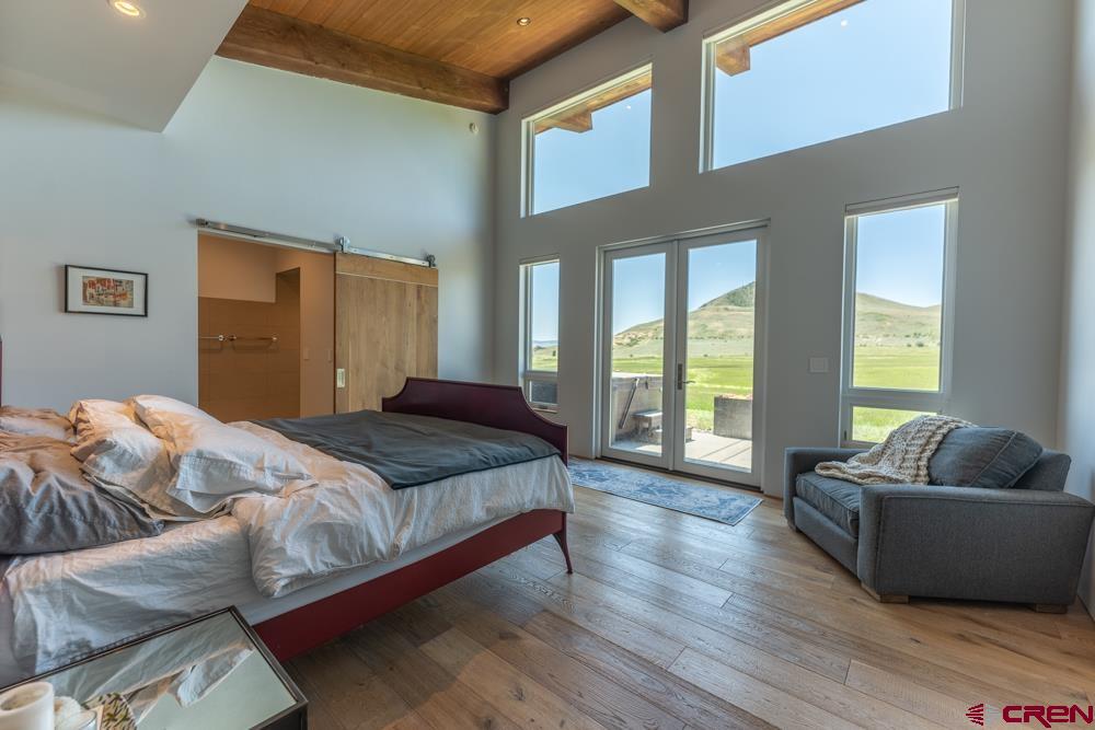 347 Overlook Trail Gunnison, CO 81230 - Photo 12 of 45 a bedroom with bed couch and window