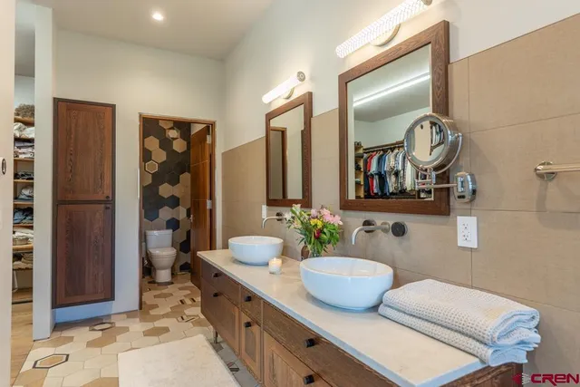a bathroom with a granite countertop sink a mirror and shower