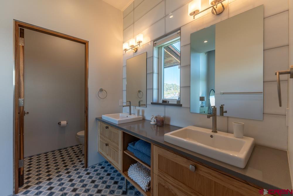 347 Overlook Trail Gunnison, CO 81230 - Photo 16 of 45 a bathroom with a sink and a mirror