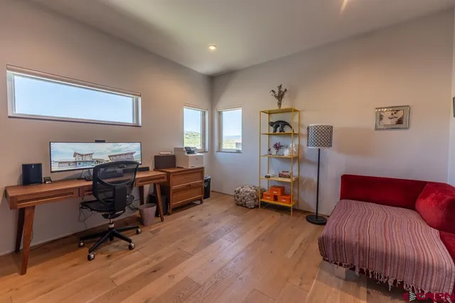 a bedroom with furniture and a wooden floor