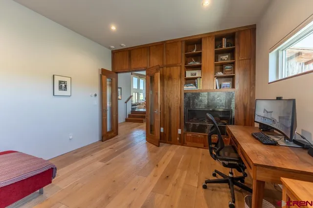 a view of a room with wooden floor and furniture