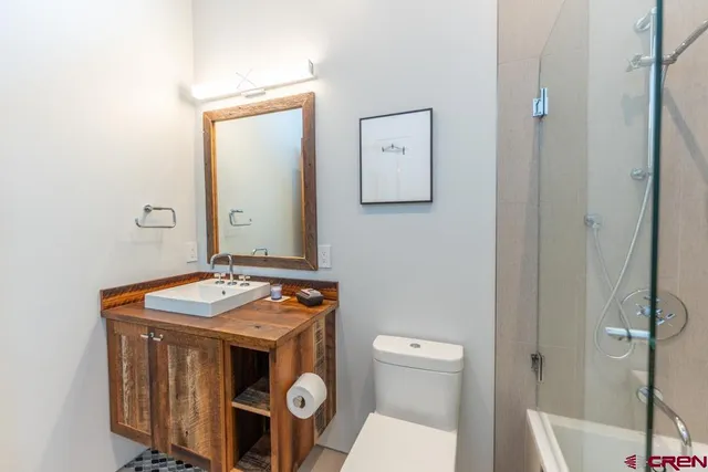 a bathroom with a sink toilet and mirror