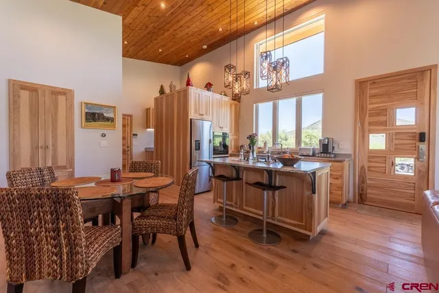 a room with stainless steel appliances kitchen island granite countertop furniture and a large window