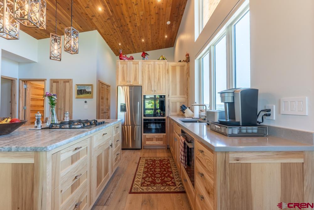 347 Overlook Trail Gunnison, CO 81230 - Photo 29 of 45 a kitchen with stainless steel appliances granite countertop a stove a sink dishwasher and a refrigerator