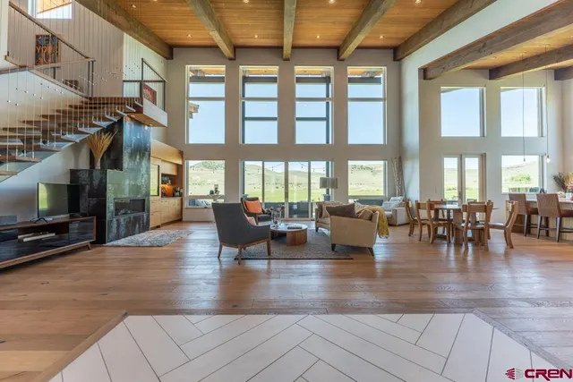 an outdoor living space with furniture and a flat screen tv