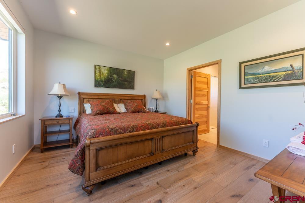 347 Overlook Trail Gunnison, CO 81230 - Photo 33 of 45 a bedroom with a bed and wooden floor