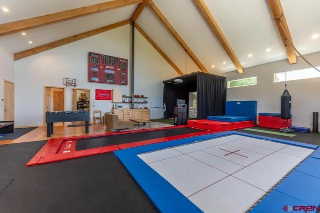 a room with lots of white furniture and walls