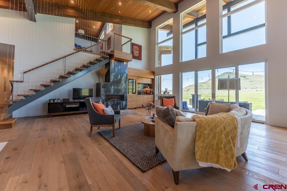 347 Overlook Trail Gunnison, CO 81230 - Photo 4 of 45 a living room with furniture or wooden floor and a floor to ceiling window