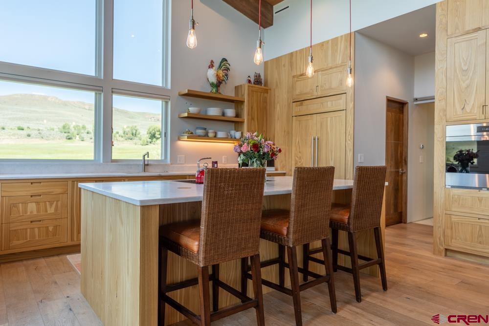347 Overlook Trail Gunnison, CO 81230 - Photo 6 of 45 a dining room with furniture a large window and a kitchen view