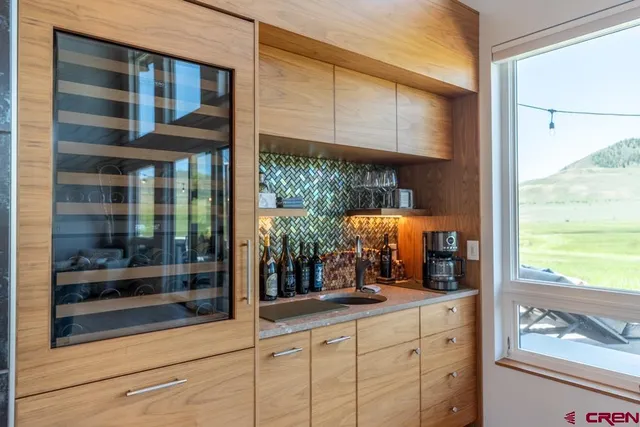 a room with wooden floor and large windows