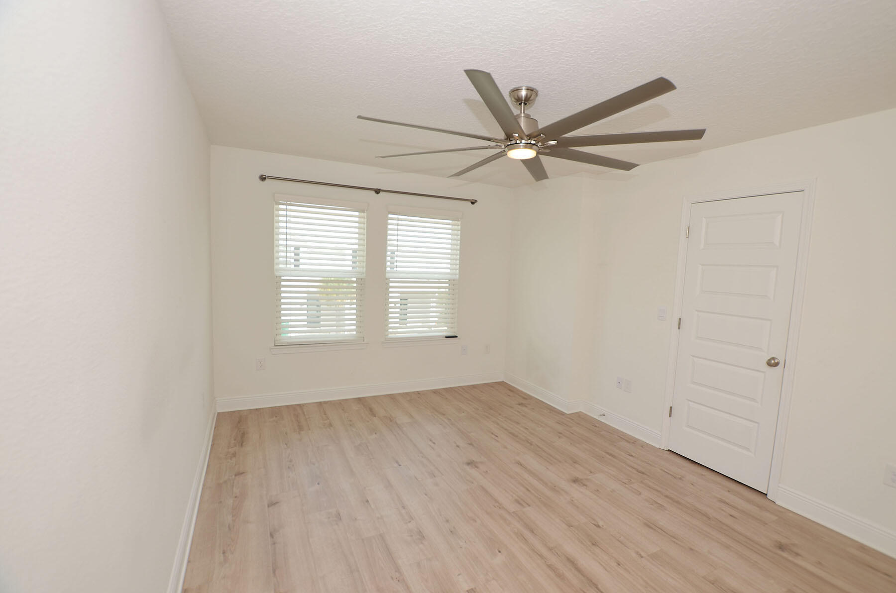 16 Redbird Loop Destin, FL 32541 - Photo 23 of 56 an empty room with wooden floor fan and windows
