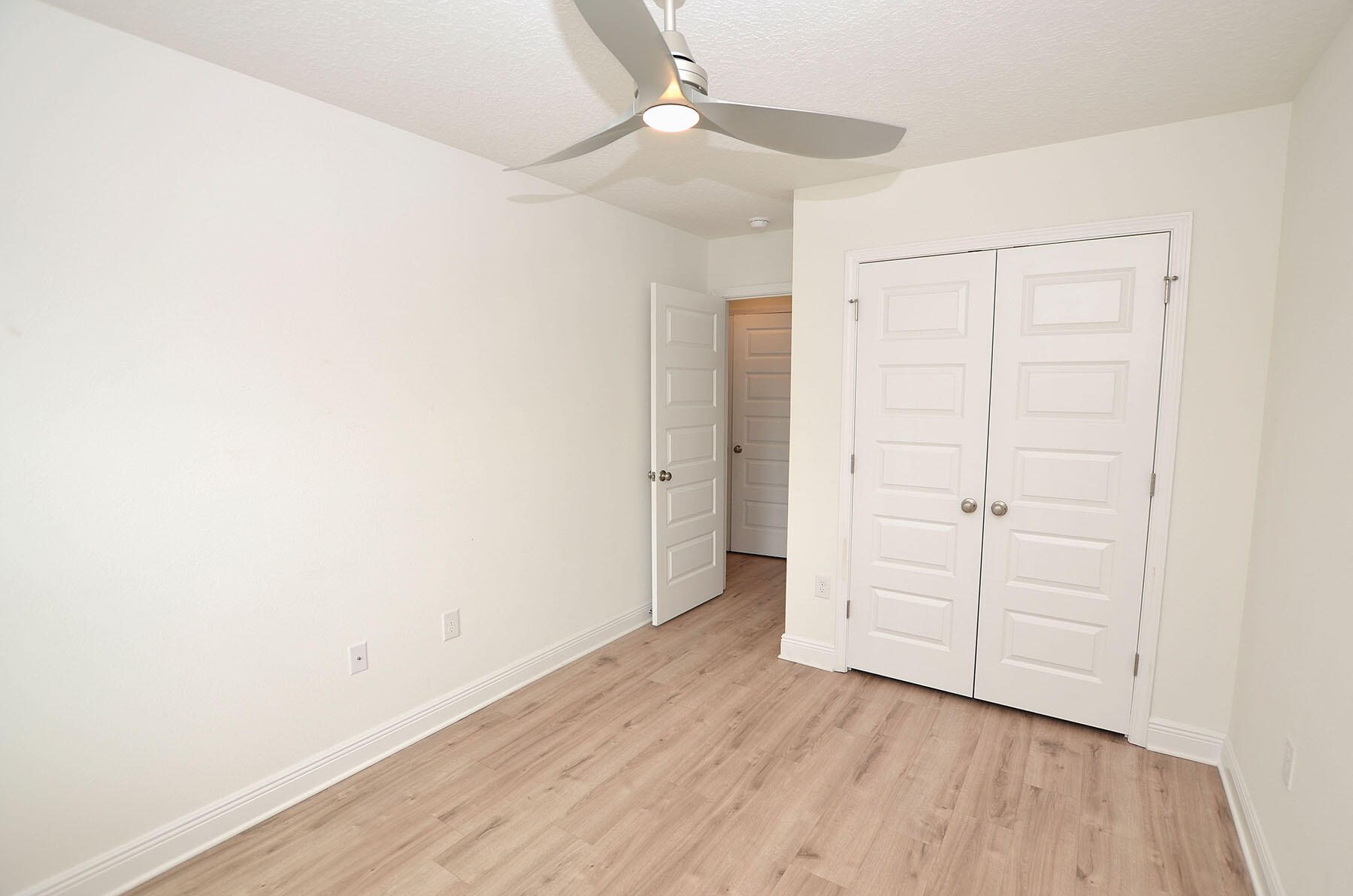 16 Redbird Loop Destin, FL 32541 - Photo 33 of 56 an empty room with wooden floor closet and windows