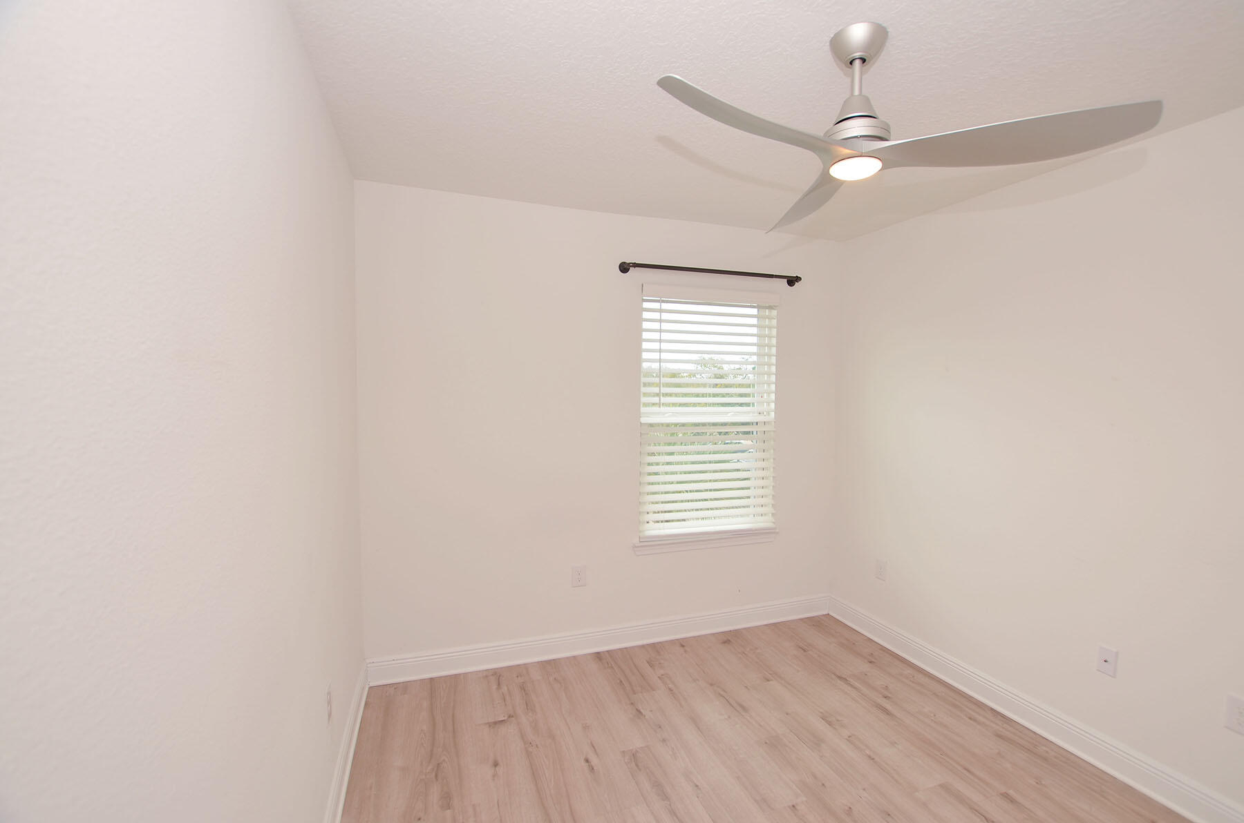 16 Redbird Loop Destin, FL 32541 - Photo 34 of 56 an empty room with wooden floor fan and windows