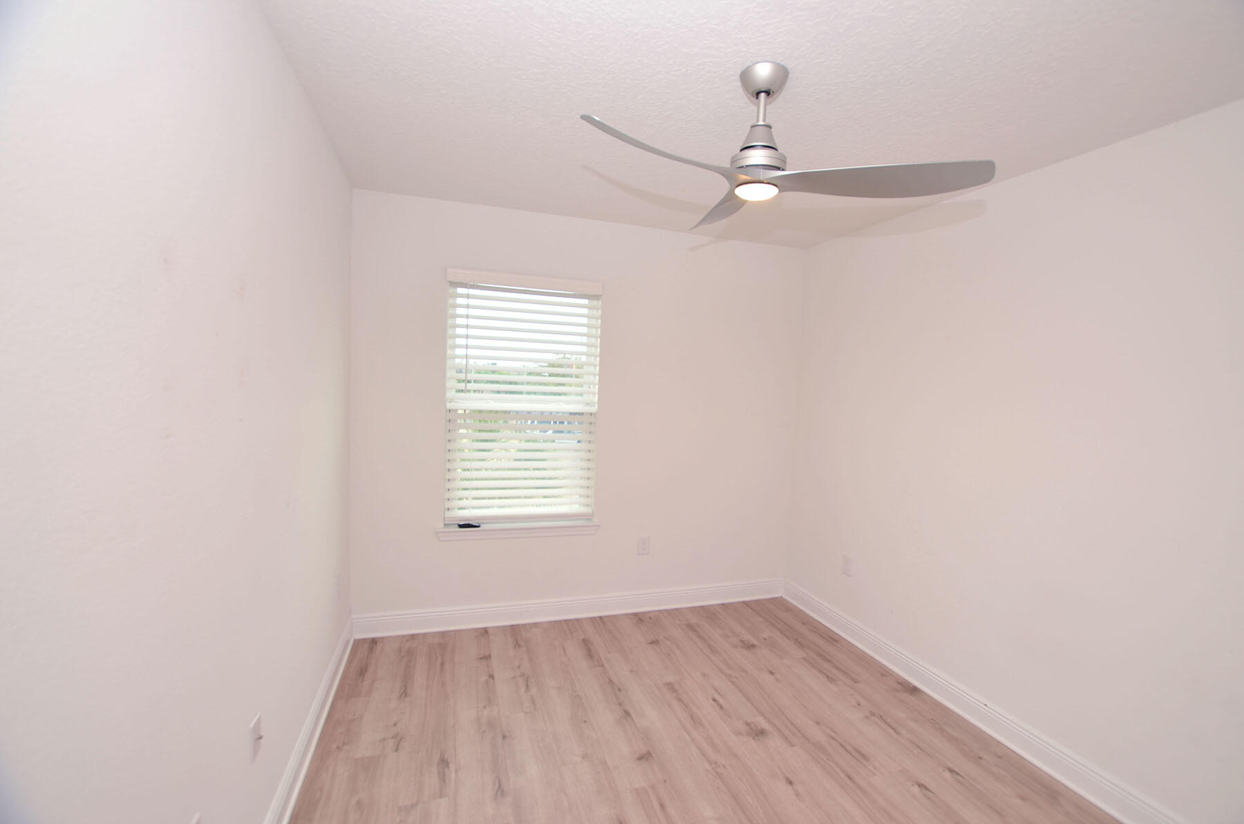 16 Redbird Loop Destin, FL 32541 - Photo 38 of 56 an empty room with wooden floor fan and windows