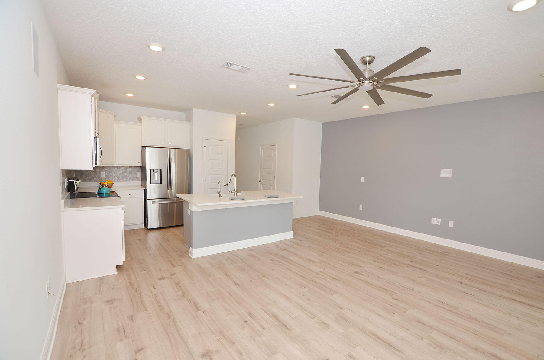 16 Redbird Loop Destin, FL 32541 - Photo 8 of 56 a view of a kitchen with wooden floor and stainless steel appliances