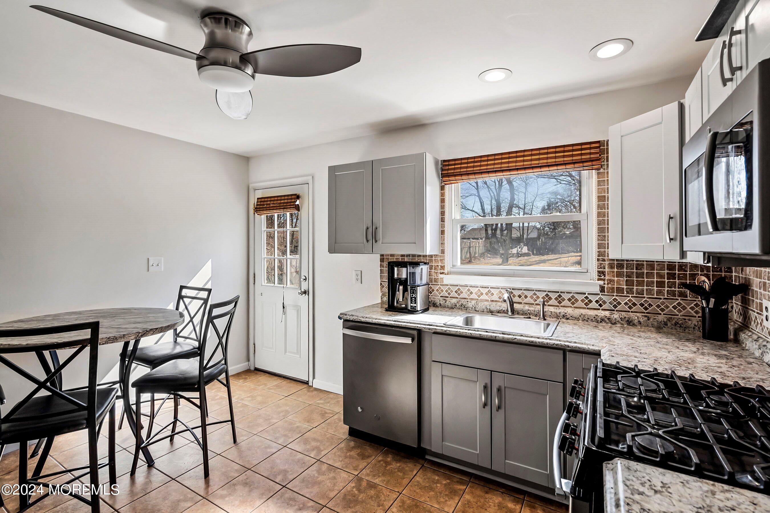 5 Hampton Road Howell, NJ 07731 - Photo 12 of 27 a kitchen with stainless steel appliances granite countertop a sink stove and refrigerator