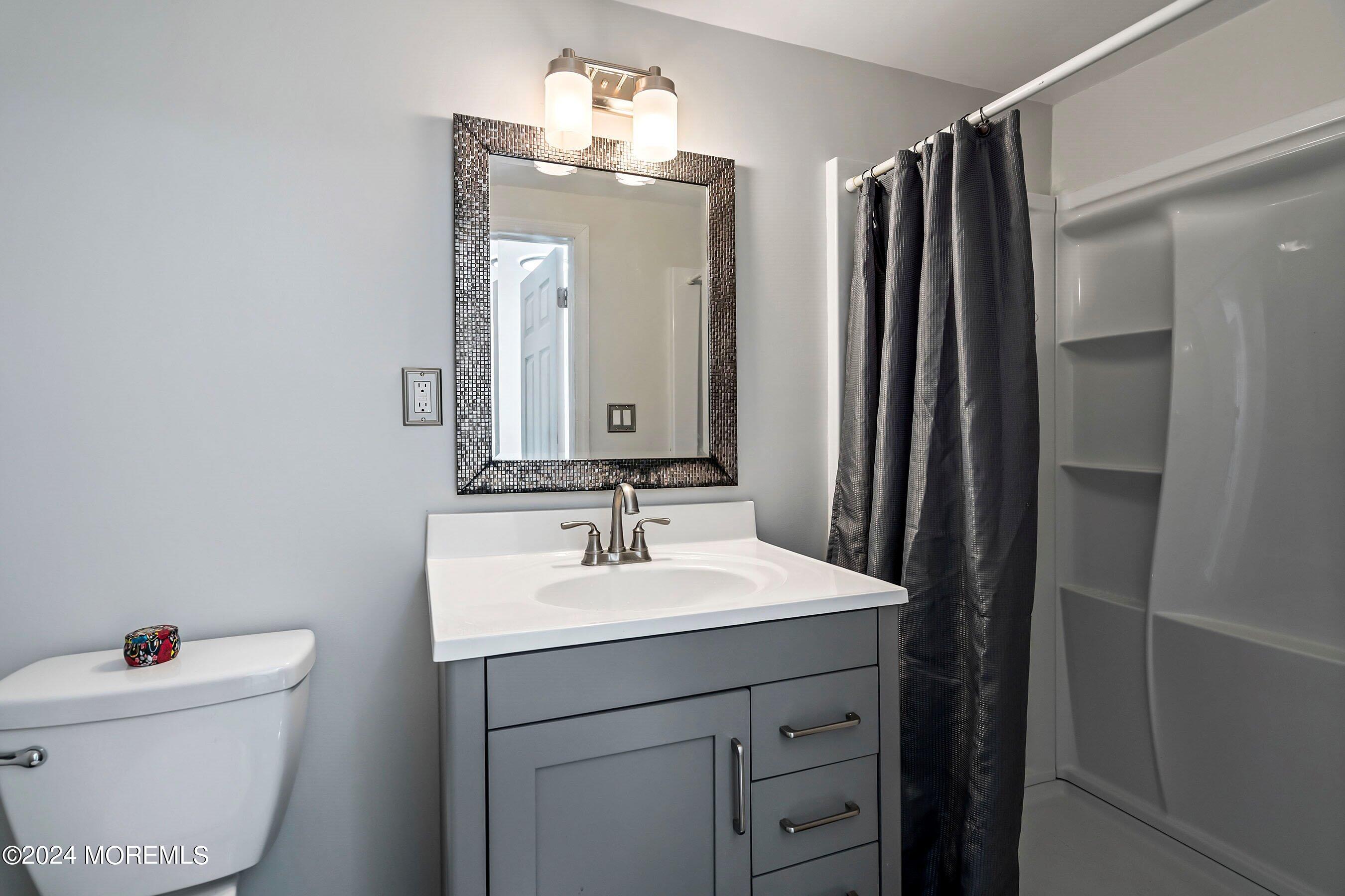 5 Hampton Road Howell, NJ 07731 - Photo 15 of 27 a bathroom with a sink vanity mirror and toilet