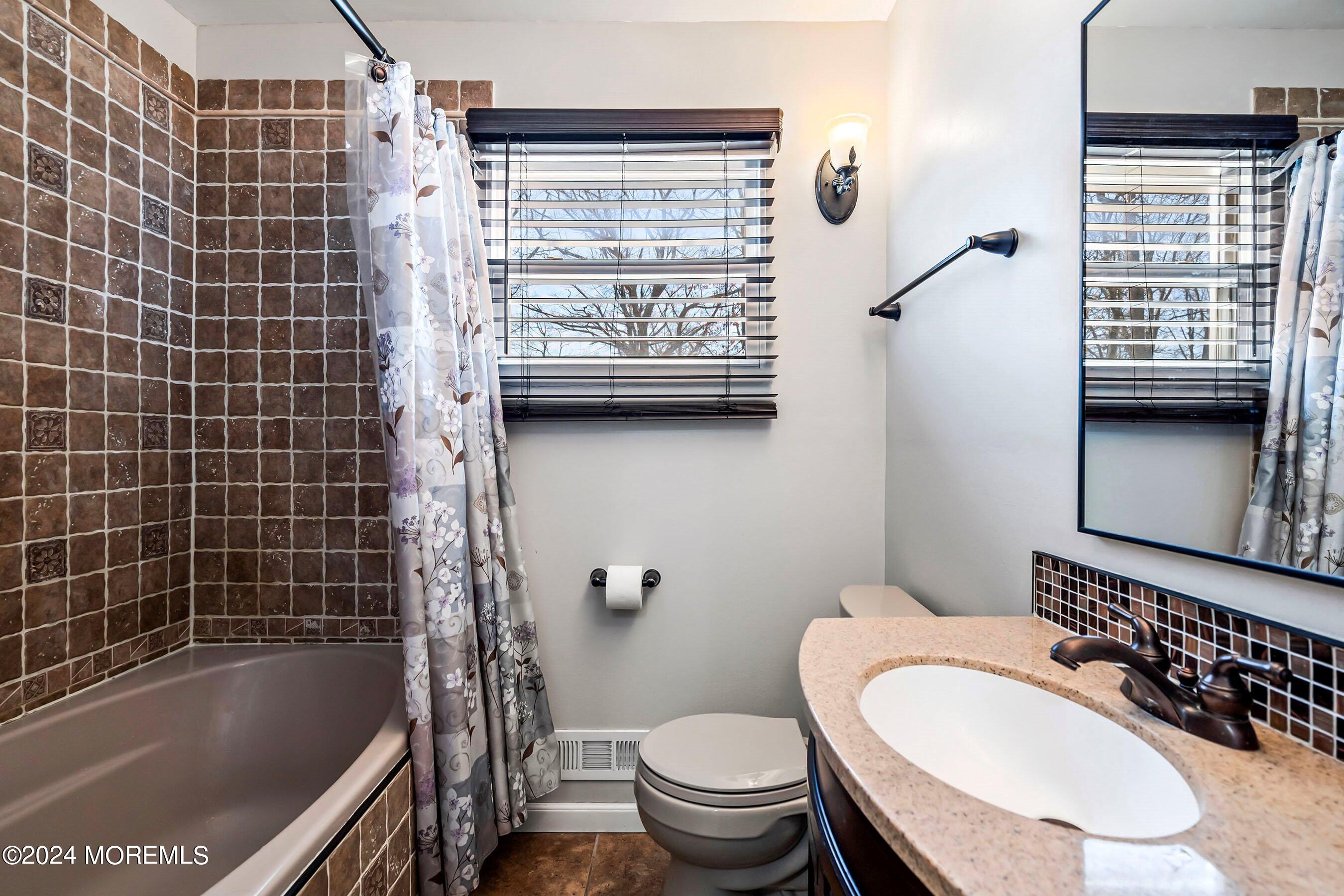 5 Hampton Road Howell, NJ 07731 - Photo 19 of 27 a bathroom with a granite countertop toilet sink and mirror