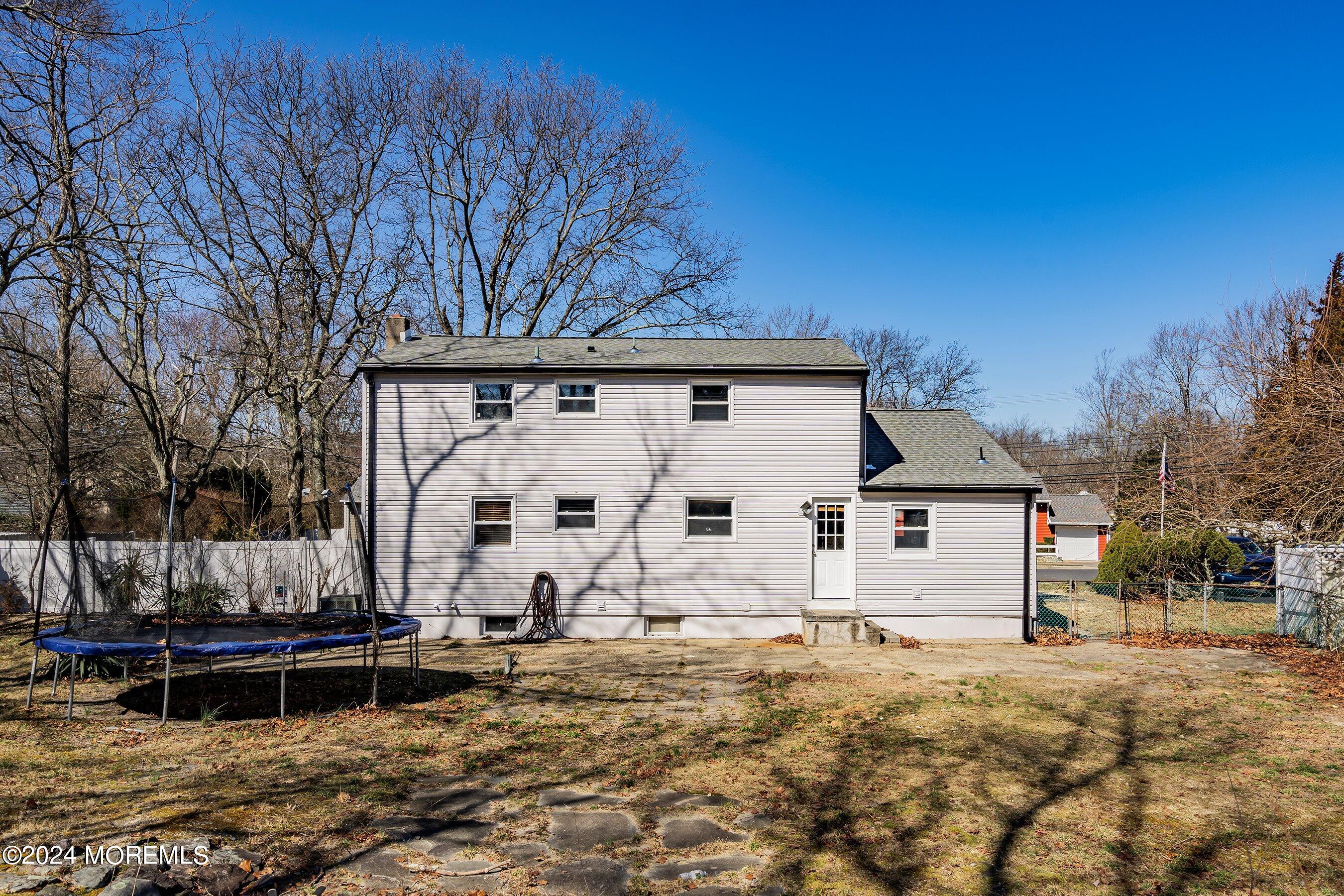 5 Hampton Road Howell, NJ 07731 - Photo 23 of 27 a view of a white house with a yard and wooden fence