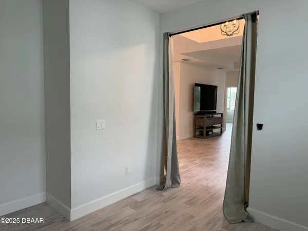 a view of a living room and a wooden floor