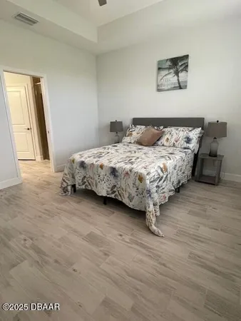 a bedroom with a bed and a large mirror
