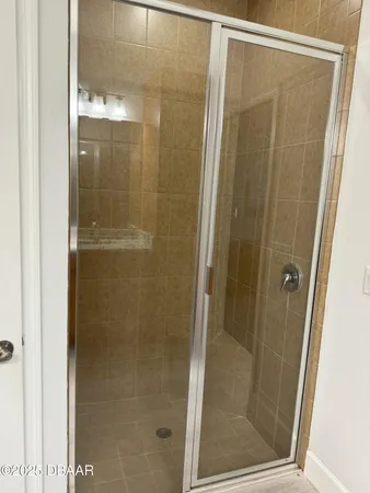 a bathroom with a glass shower door