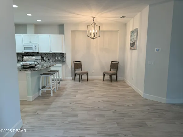 a kitchen with stainless steel appliances granite countertop a stove and a refrigerator