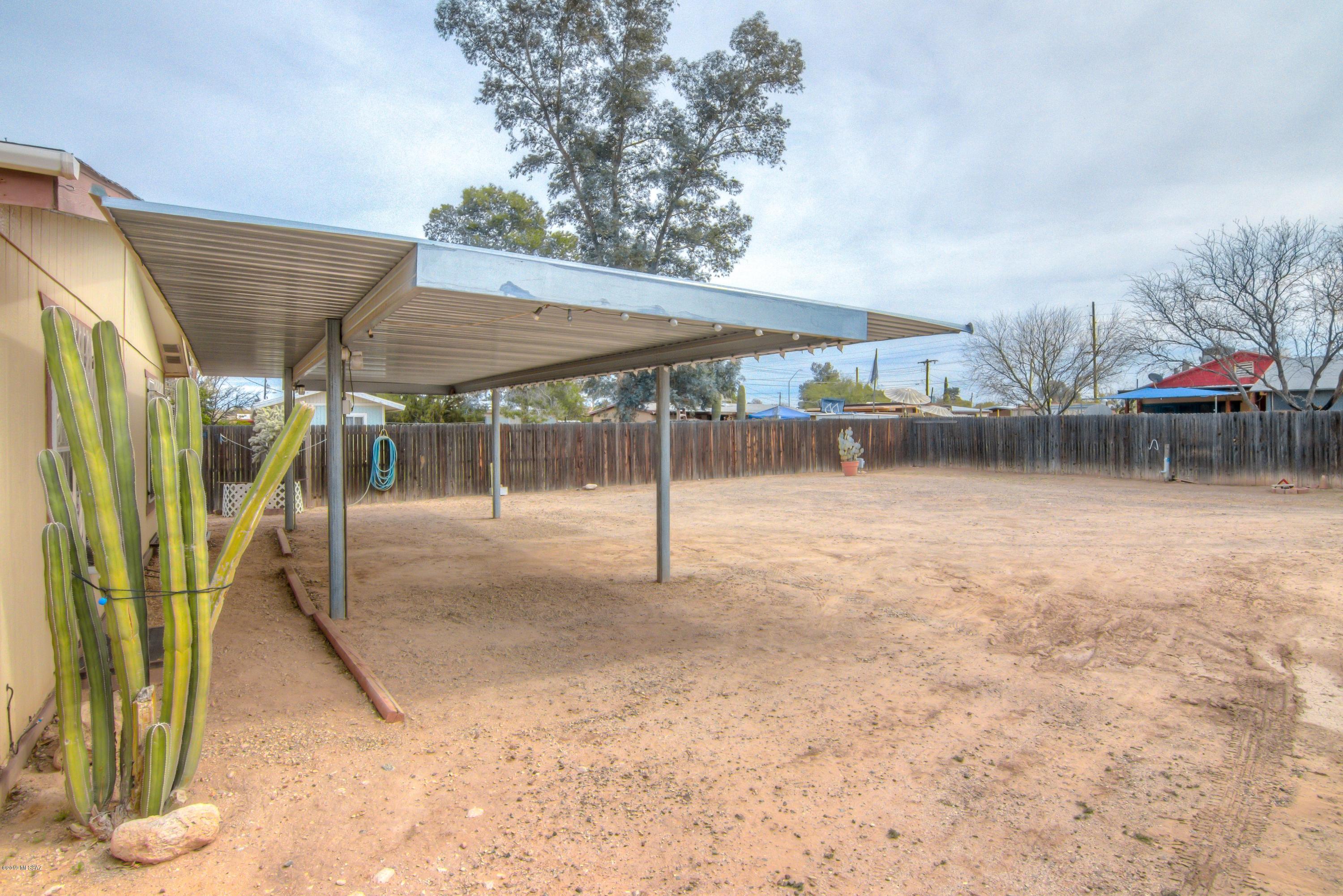 263 East Roger Road Tucson, AZ 85705 - Photo 2 of 31 a backyard of a house with table and chairs