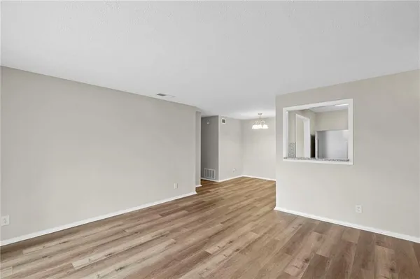 a kitchen with cabinets stainless steel appliances and wooden floor