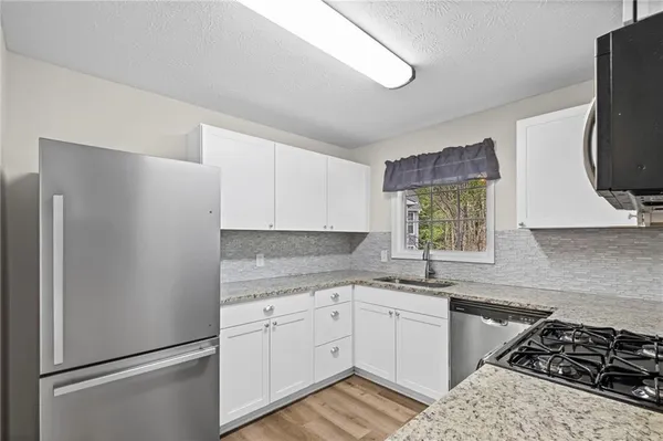a kitchen with a refrigerator and cabinets