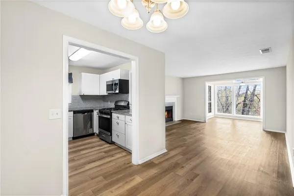 a view of wooden floor and a window in a room