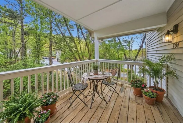 a view of balcony with furniture and wooden floor
