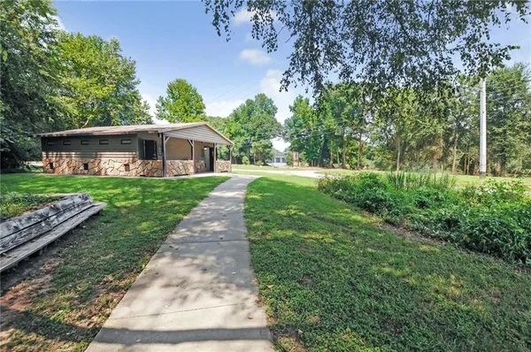 a view of a swimming pool with a lawn chairs and floor to ceiling window