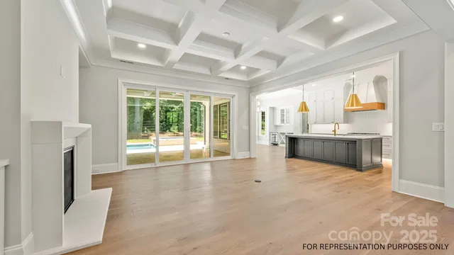 a view of an empty room with a fireplace and a window