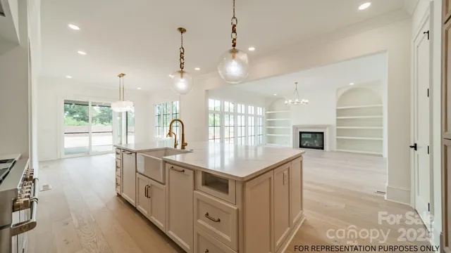 a kitchen with kitchen island a sink stove and wooden floor